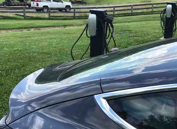 How far can a Tesla go on one charge at 70 mph?